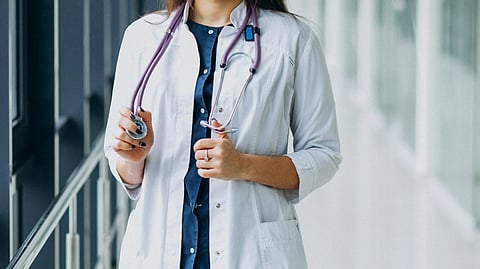Young woman doctor with stethoscope at hospital