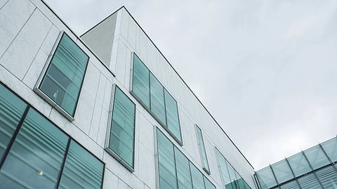 Modern building with large, rectangular glass windows.