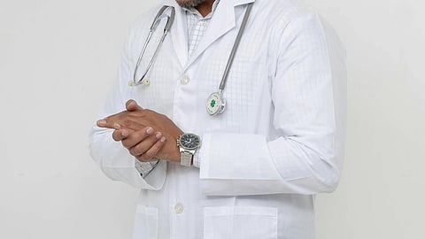 Doctor wearing a white court, stethoscope on hand