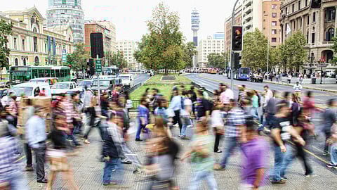 Many people walking across a road.