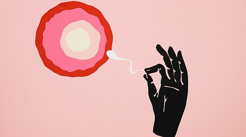 An illustration showing a hand gently holding a sperm cell as it moves toward an ovum.