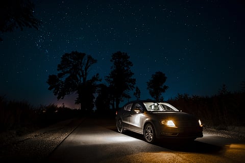 A car at night with interior lights on a highway.