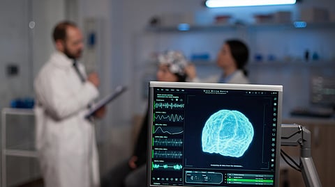 Two doctors discussing about something and a brain imaging on focus. 