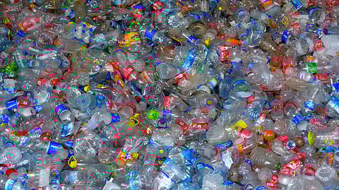 A dense collection of colorful, discarded plastic bottles and caps.