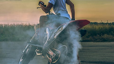 Man on bike doing stunt.