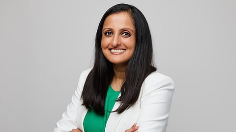 Dr. Nisha Patel wearing a white apron and Green top