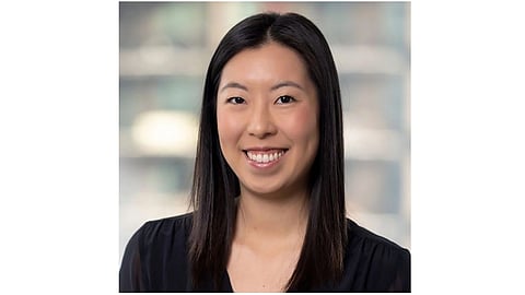 Image of Wendy Wang wearing a black top and smiling toward the camera.