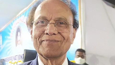 close up of Dr. Nori Dattatreyudu face having greyish hairs and wearing a sleek transparent specs.