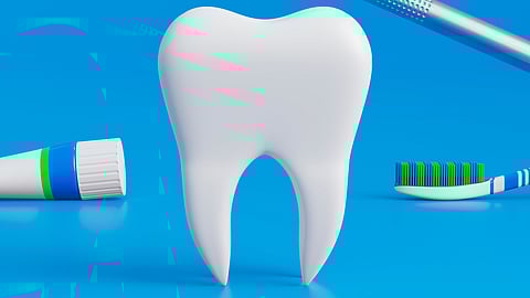 A large white tooth at the center, with a magnifying mirror highlighting a smiling tooth. A toothbrush and toothpaste are placed on either side, representing oral hygiene and dental care.