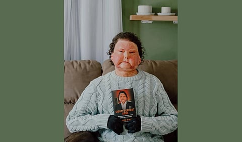 Joe DiMeo holding a book