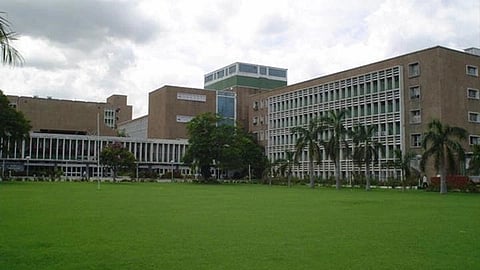 AIIMS Delhi main building in brown with its surrounding garden, showing greenery.