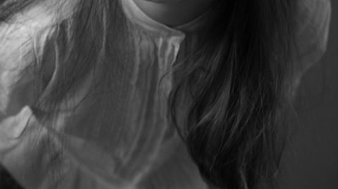 Black-and-white illustration depicting the upper body of a girl, focusing on her clothing.