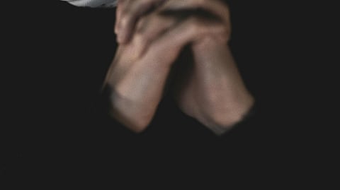 A blurred close-up image of woman hands bind to each other.