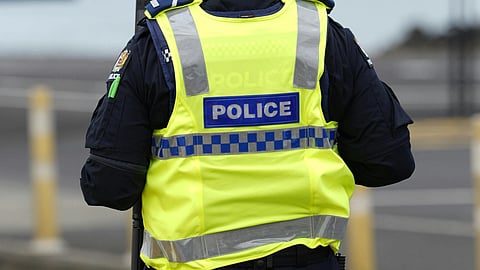 A police man wearing a police jacket in neon.