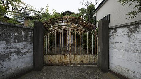 Old abandoned house with rusty gate