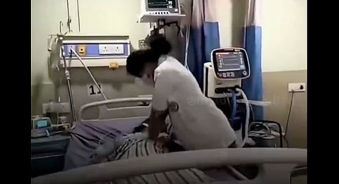 A woman doctor performing CPR on a patient in an intensive care unit. 