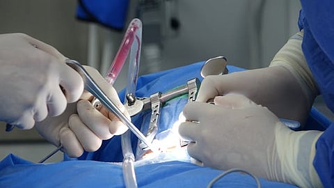 surgeons performing complex spinal surgery