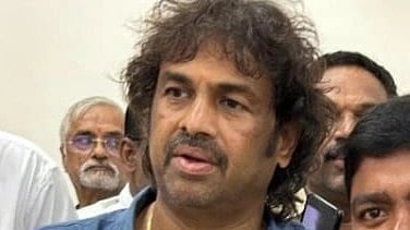 Literacy Minister Madhu Bangarappa in blue shirt.