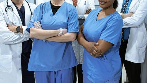 2 nurses and 2 doctors standing.