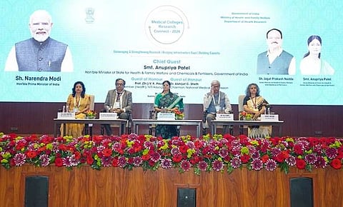 Few people sitting on a stage in an event for health ministry India.