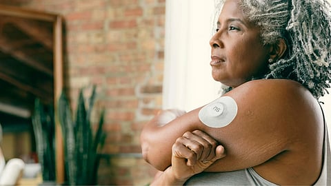 A woman wearing a white band on her arm.
