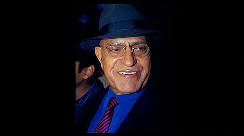 Amrish puri in blue shirt and hat.