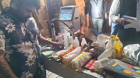 Few men checking the food samples in the warehouse and looking at the documents related to it. 