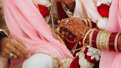Indian bride and groom's hands on traditional wedding ceremony.