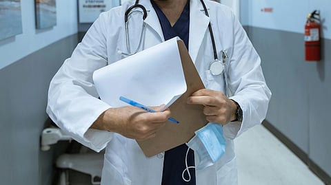 A doctor with stethoscope and note pad.