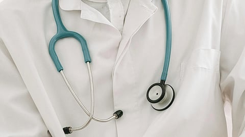 A man in white coat with stethoscope.