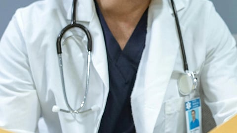 A doctor in white coat with stethoscope.