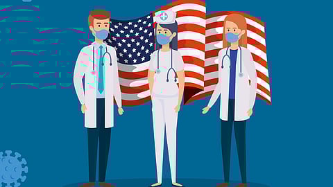 Illustration of three healthcare workers in masks and scrubs, standing in front of a waving American flag. 