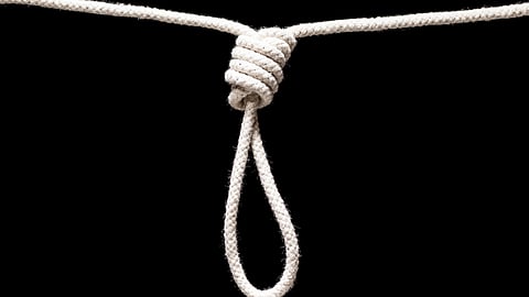 A white rope tied in a noose against a black background.