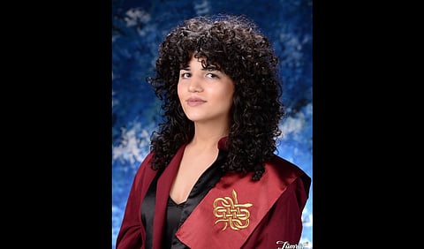 Dr. Larin Kayataş wearing a convocation gown.