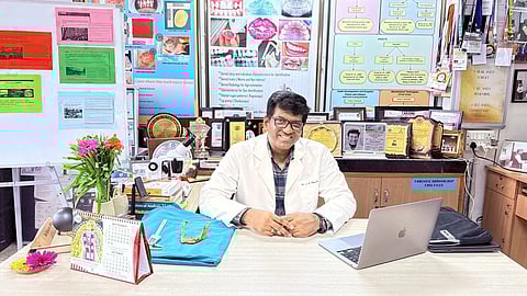 An image of Dr. Jayasankar Pillai sitting at his table.
