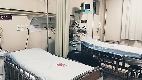 2 hospital beds kept in a hospital room.
