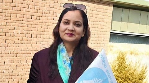 Nisha Mehta in blue saree and wine colored coat.