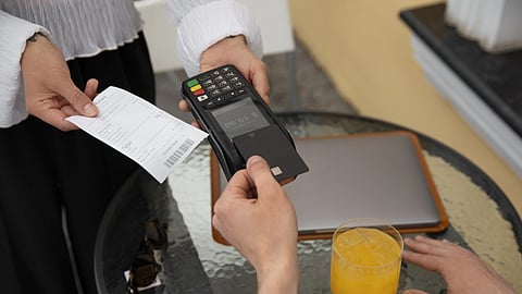 High angle customer paying with nfc device