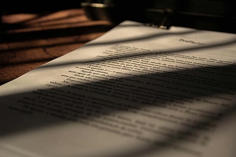 Illuminated document resting on table surface.