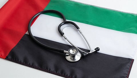 UAE flag draped over table with a stethoscope resting on top