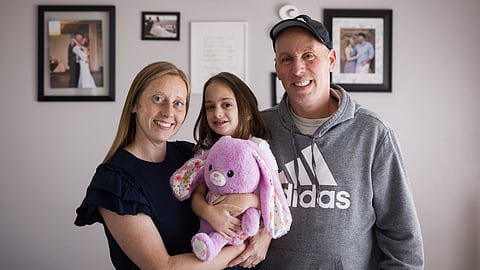 Ollie Super, a foster child, sit with her parents, Britany and Jason, at their home in North Carolina. 