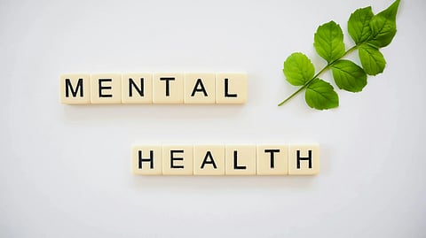 Scrabble tiles spell "MENTAL HEALTH" on a white background.