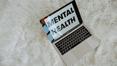 A laptop kept open and on screen text of mental health.