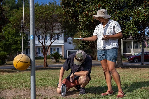 Verite reporter Tristan Baurick tests lead levels while reporter Halle Parker maps the GPS
coordinates of the reading at Mirabeau Playground, in New Orleans’ Gentilly neighborhood, in September 2025