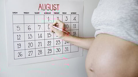 Pregnant woman counting down for delivery date.