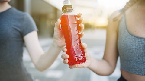 Women with red drink in bottle. 