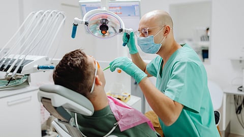 A dentist treating on a patient.