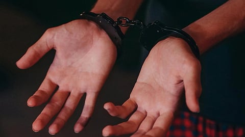 2 hands with hand cuff.