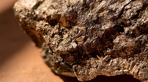 Close-up of a pyrite rock, known as fool's gold, with its metallic, golden hues and rough texture.