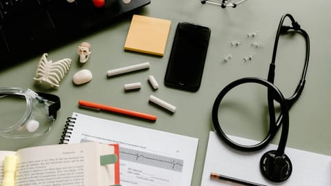 Stethoscope, books, chalk kept on table.